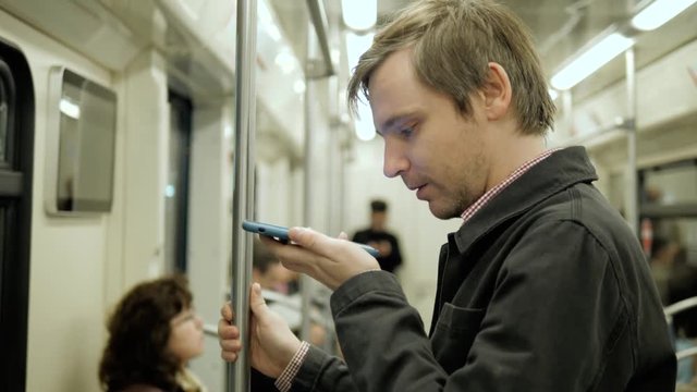 Man voice recognition with smart phone in subway underground railway station train public transportation