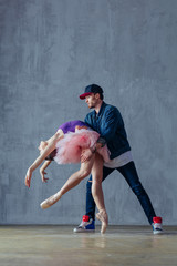 Young beautiful dancers are posing in the studio