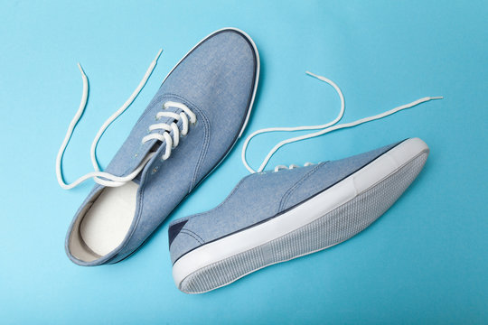 Fashionable casual blue sneakers on blue background.