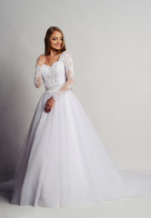 Fototapeta na wymiar Beautiful bride in wedding dress, white background