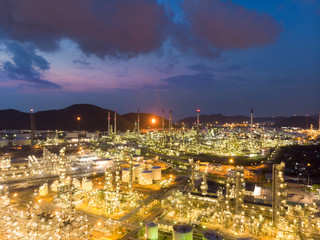 Fototapeta premium Aerial view of steel pipe oil refinery plant, power plant at sunset sky for industry concept.