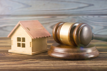 Obraz premium house, hammer of a judge on a wooden background. real estate.