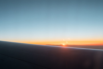 Fototapeta na wymiar sunrise in the himalayas mountains from the airplane window.