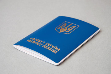 Foreign passport of Ukraine is isolated on a gray background with space for copying. Emigration from Ukraine to the European Union.