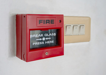 Fire alarm switch inside red plastic box
