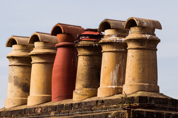 old chimneys of a roof of an old house in the UK