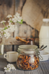 Organic granola and flowers on a wooden table.  Food background