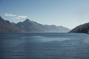 Fototapeta na wymiar Paisaje de montañas frente a un lago. Escena diurna, cielo azul y despejado. Nueva Zelanda.