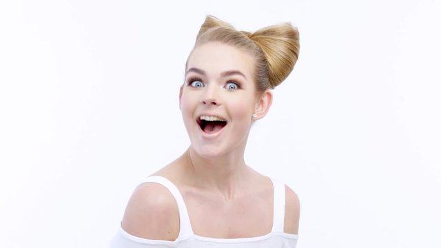 Portrait of an young surprised woman with happy emotions.