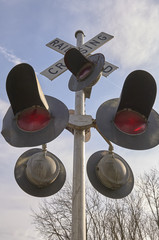 railroad crossing signal with lights and sign