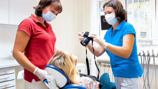 Portrait of dentist making image of patients teeth before treatment