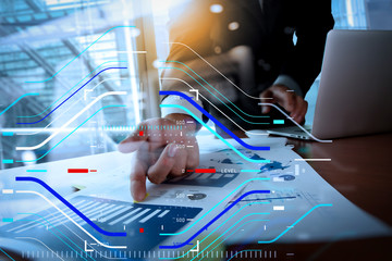 Double exposure of business man hand working on blank screen laptop computer on wooden desk as concept