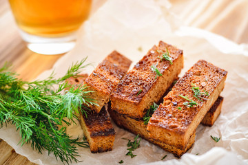 Rye croutons with dill and a glass of beer