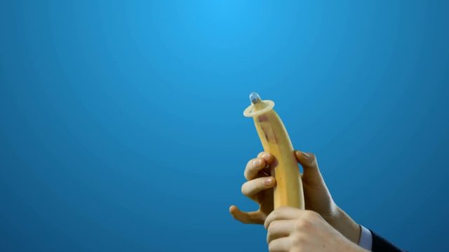 Condom on Banana Sex Education Video on Green Screen 4k Video Footage Clip.