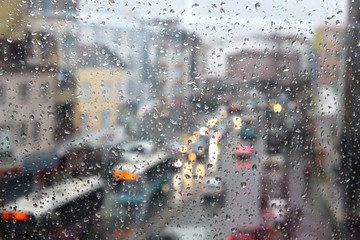 Water droplets on the window and the background silhouette of the city
