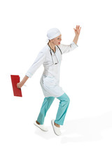 Beautiful young woman in white coat running at studio. Full length studio shot isolated on white.