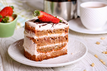piece of cake on white plate with strawberries