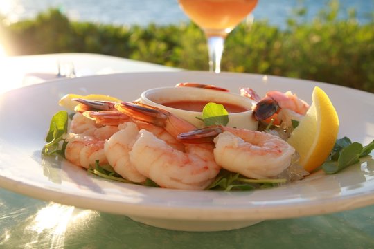 Shrimp Appetizer Platter with Lemon Slices Accompanied by a Ginger Martini Overlooking the City of Miami Skyline Near Sunset in Key Biscayne, Florida