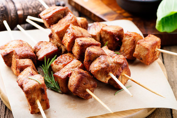 Barbecue meat. Grilled pork skewers on wooden table.