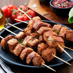 Barbecue meat. Grilled pork skewers on wooden table.
