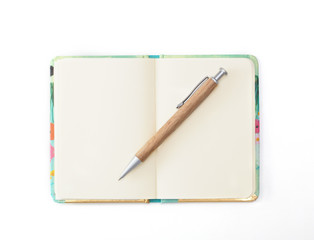 Decorative diary with a wooden pen lying on it