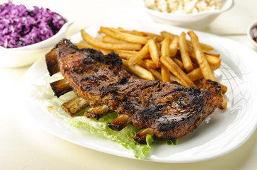 baked ribs and French fries and cabbage salad