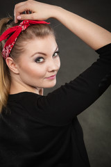 Portrait of retro pin up girl in red handkerchief.