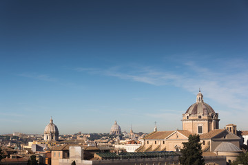 Fototapeta na wymiar Church domes and rooftops of old buildings in Rome