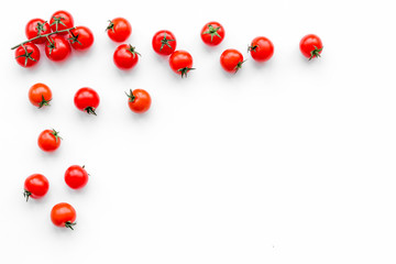 Fototapeta premium Fresh red tomatoes scattered on white background top view copy space