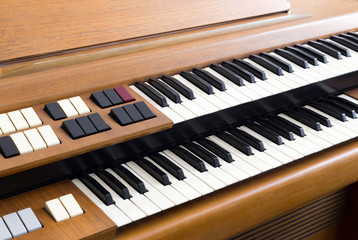 Fototapeta na wymiar Closeup of the knobs and keyboard of an old electric organ