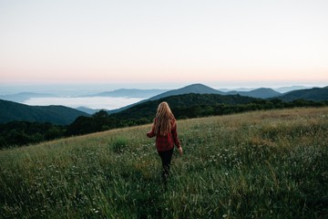 Woman Walking in the Morning On A Mountain
