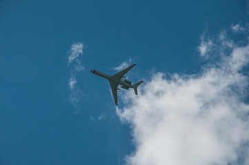 passenger plane flying against the blue sky and clouds. closeup