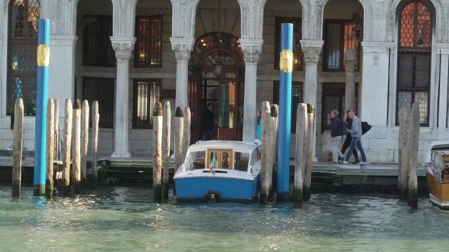 2356_A_white_speedboat_docking_on_the_side_of_the_canal_in_Venice_Italy.mov