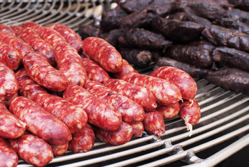 Grilled sausage on the flaming grill