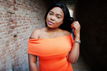 African american woman model xxl in orange dress.