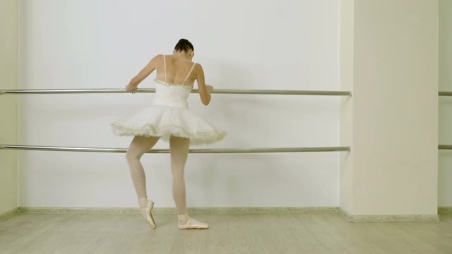 Classical ballet. Ballerina dancing in pointe shoes in dance studio. 4K