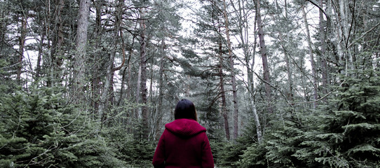 Woman in Red Standing in the Middle of the Forest Alone