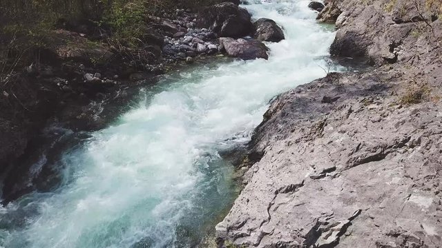 flying over a waterfall with a 4k drone - aerial cinematic view shot on sunrise