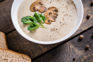 A bowl of mushroom soup cream on the table