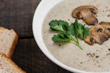 A bowl of mushroom soup cream on the table