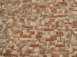 Natural stones wall texture made of irregular shape  rocks. Colors are brown,white and grey