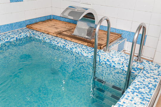 Small swimming pool with blue fresh water at the bath complex, hardening concept