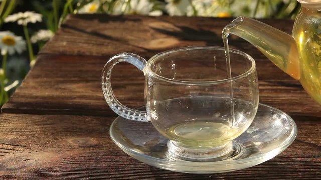 Crystal cup with green tea on table