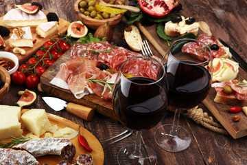 Italian antipasti wine snacks set. Cheese variety, Mediterranean olives, pickles, Prosciutto di...