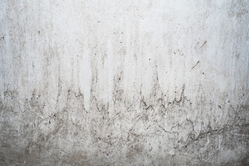 grunge light gray texture of an old wall with black divorces, white surface with smudges, abstract background
