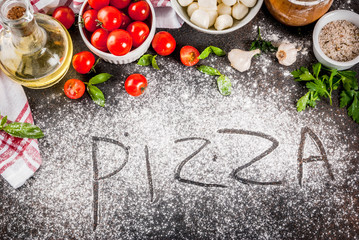 Obraz na płótnie Canvas Homemade pasta pizza italian food ingredient on dark rusty table with flour, olive oil, basil, tomatoes and kitchen accessories top view