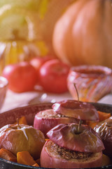 Autumn sweet dish baked apples and pumpkin in a frying pan with honey close view