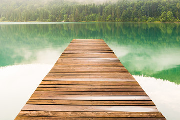 Naklejka premium See mit Wald und Nebel in Herbst Stimmung - Walchensee mit Steg