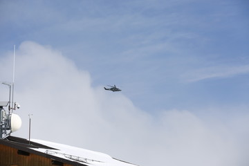 Military helicopter. Italian military helicopter in the sky. Military helicopter against the background of a blue sky.