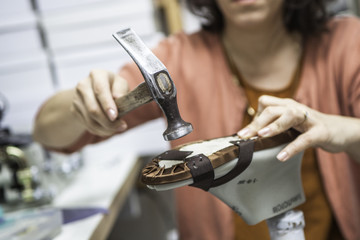 Woman designer making handmade shoes in her workshop